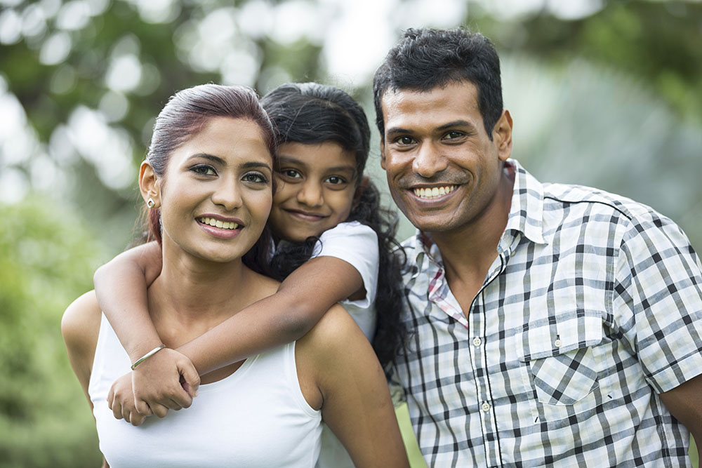 Happy Indian family at the park.